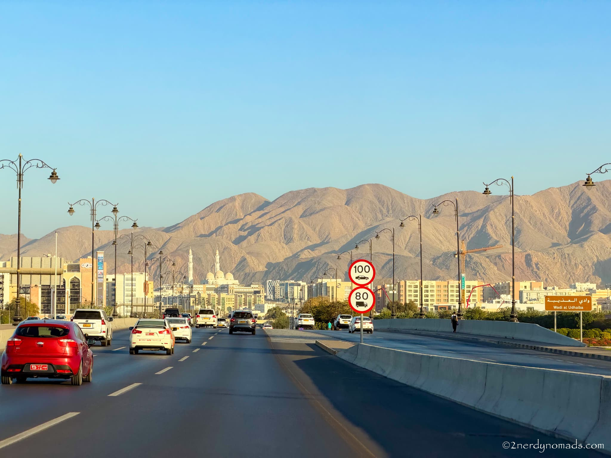 Scenic highway in Oman with the Hajar Mountains in the background during our two-week Oman road trip.